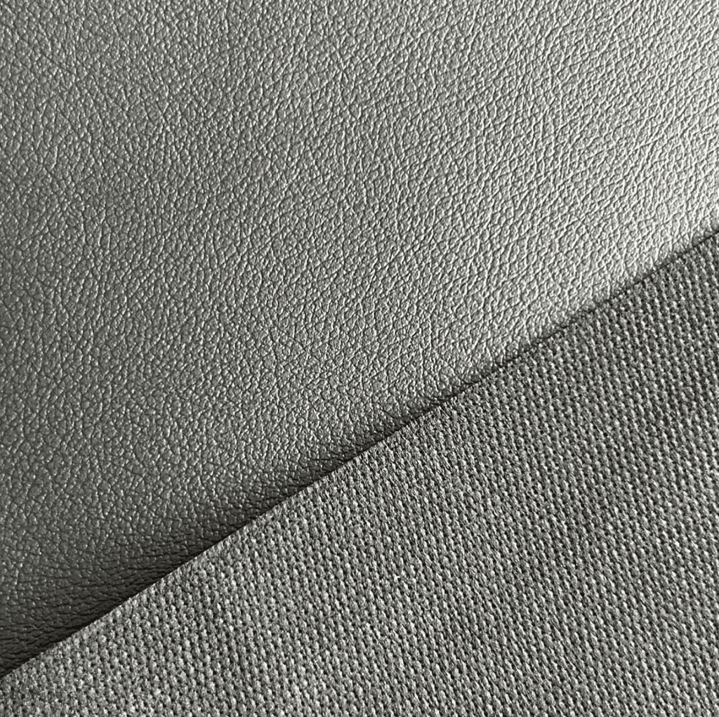 Close-up of PVC synthetic leather showing a coated surface and embossed texture