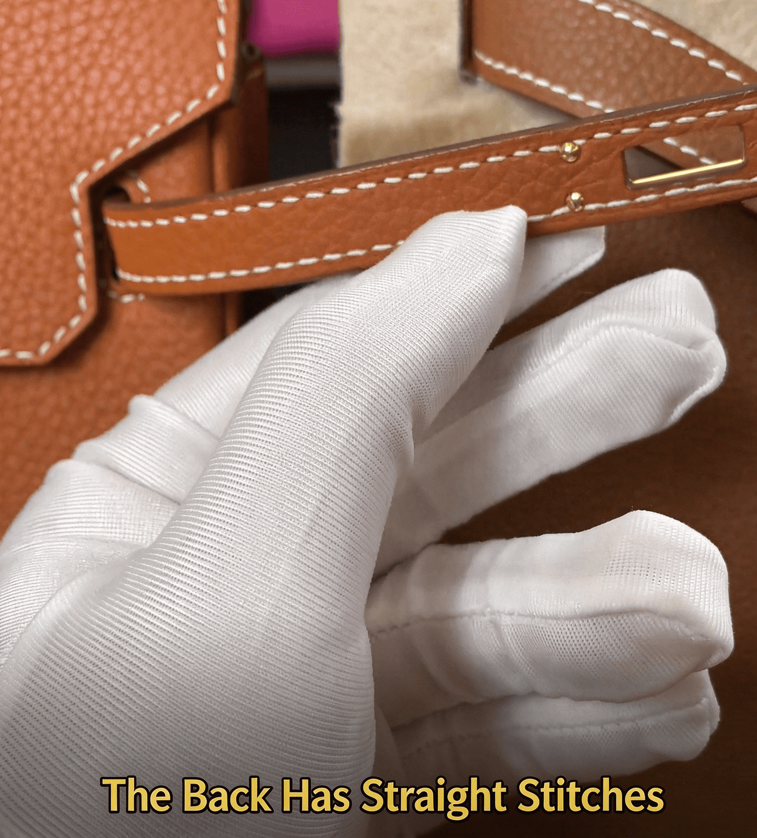 The back has straight stitches, brown leather belt with white stitching, white glove holding luxury bag part, craftsmanship inspection, leather sewing detail
