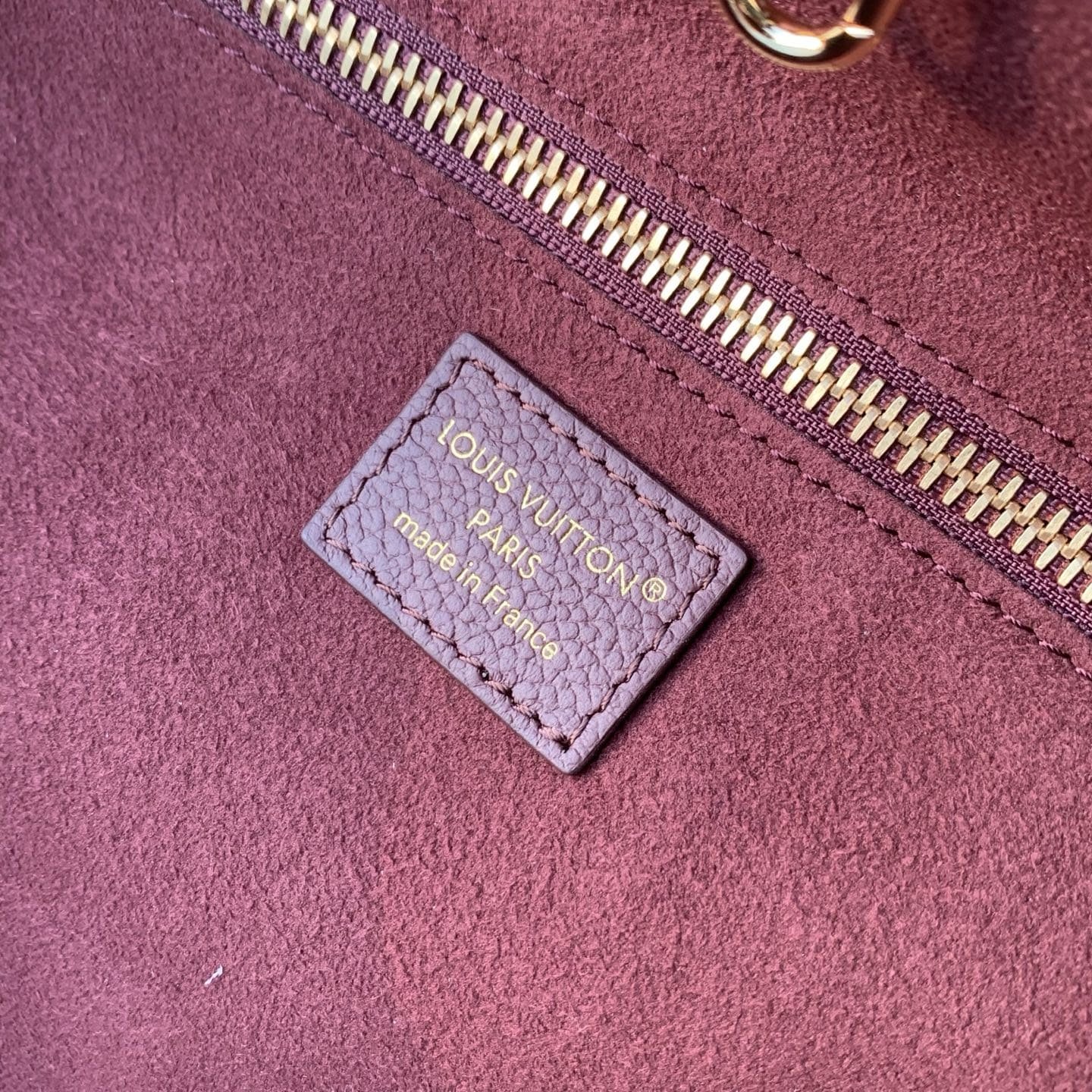 Louis Vuitton leather label tag detail inside Neverfull Empreinte luxury handbag