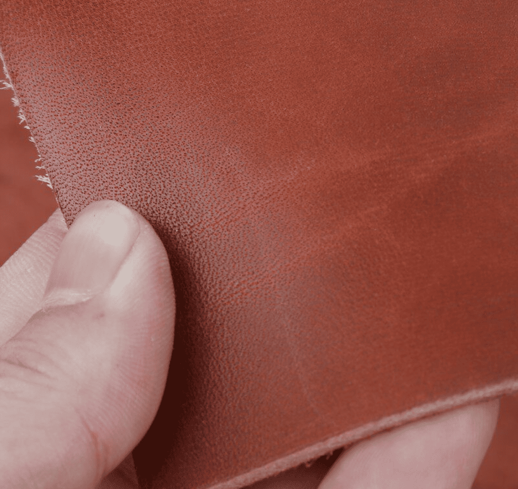 Close-up of vegetable-tanned cowhide leather in a warm natural tan color